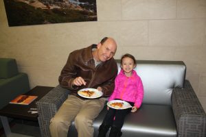 Father and Daughter Eating Pizza